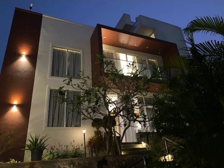 Mer Vue Villa lit up at dusk